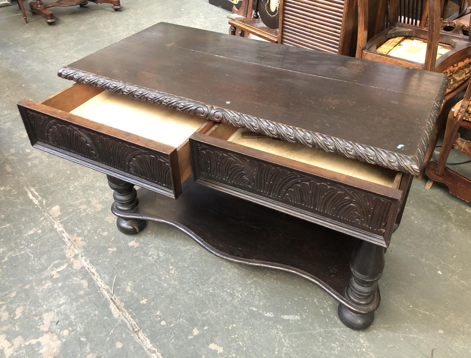 A Victorian side table with two frieze drawers with carved fronts, on baluster supports, on - Image 2 of 2