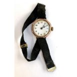 An early 20th century 9ct gold cased Swiss jewelled lever wristwatch on a black fabric strap,