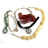 A mixed lot of jewellery to include a coral multi strand necklace; bone necklace; faux pearls etc
