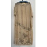 A 1920s silk shift dress with beaded floral design (af), bears label for size 40, 110cm long