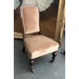 A Victorian rosewood bedroom chair, upholstered seat and back, on turned legs and brass casters