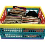 A plastic crate of 7 inch singles to include Aretha Franklin, Yoko Ono, Rick Astley, Simply Red,