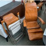 A pair of folding brown vinyl deck chairs