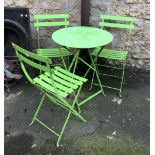 A set of three bright green garden chairs, together with matching table