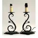 A pair of wrought iron table lamps of scrolling form, 37cmH to top of fitting