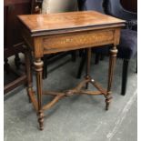 A French style games table, marquetry inlay, foldover leather inset top, on tapering fluted legs and