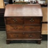 An 18th century oak bureau, fall front over two short and two long drawers, on bracket feet,
