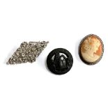 A white metal brooch set with paste, closed back, 6.5cmW; together with a silver mounted shell cameo