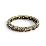 An Art Deco 9ct white gold and paste full eternity ring, size O, approx. 2g