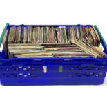A blue crate of 7 inch singles to include Leo Sayer, The Wombles, etc