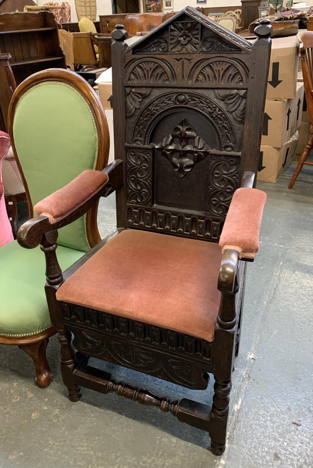 A Victorian oak open armchair, carved in the Jacobethan taste, with upholstered arms and seat, 56cmW