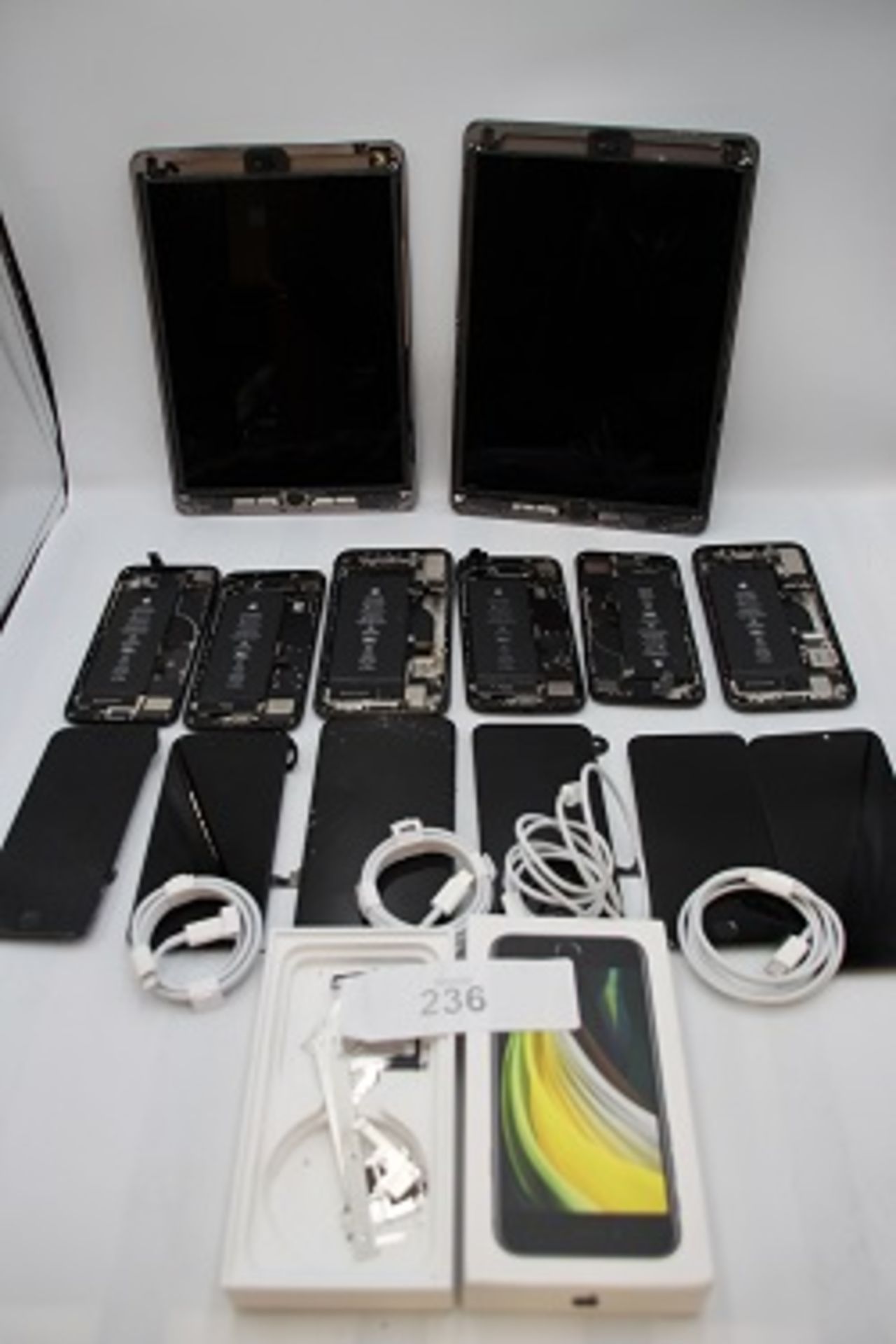 A selection of Apple iPhone spares including chassis, batteries and screens, logic boards