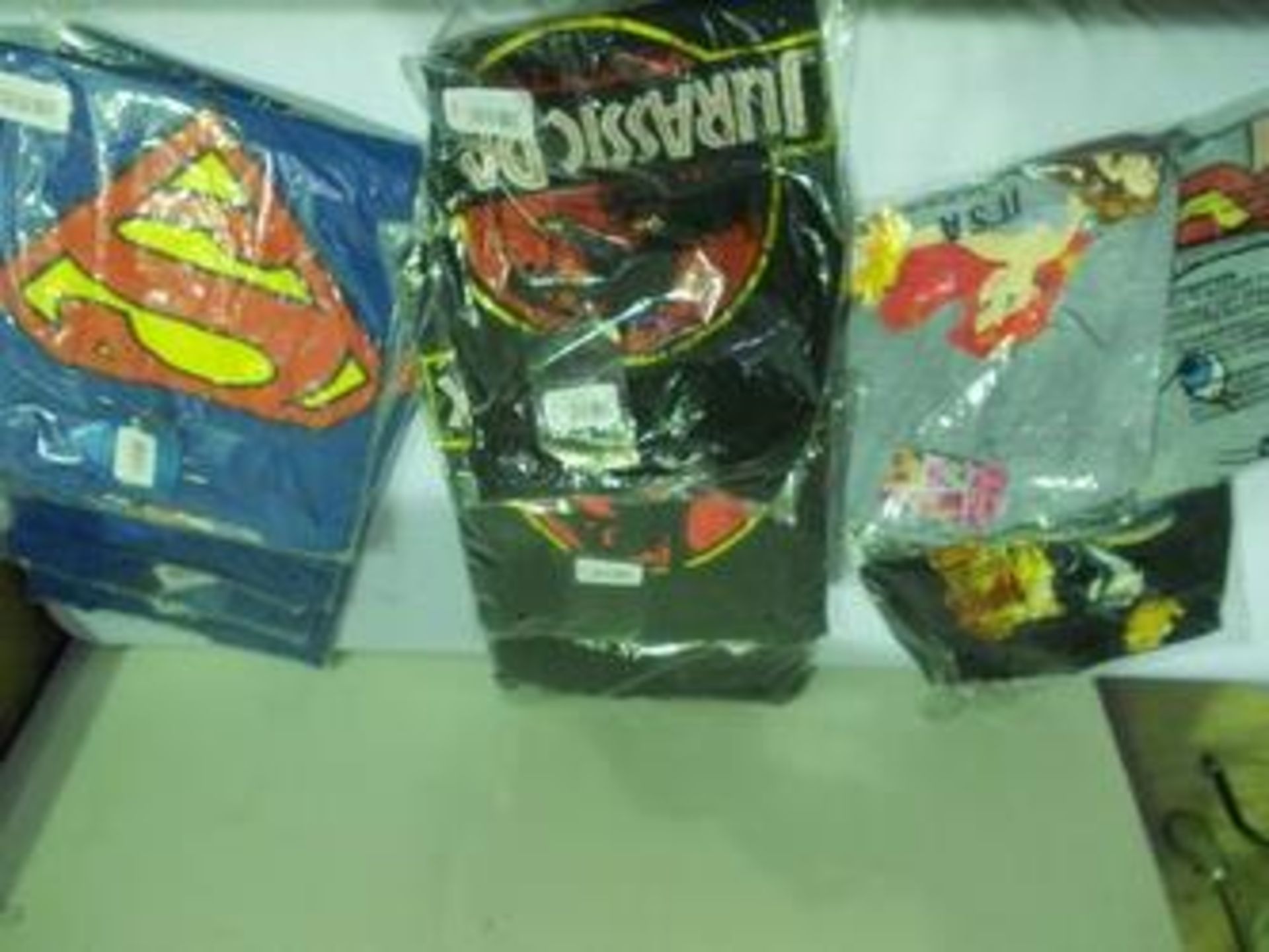 12 x items of Superman, Jurassic Park and Disney Official Merchandising clothing in various sizes,