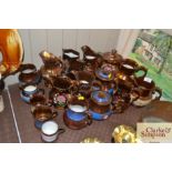 A quantity of copper lustre ware jugs and mugs