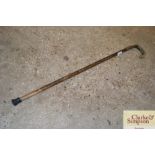 A white metal mounted walking stick