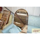 An arched bevel edged wall mirror