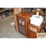 An Edwardian walnut music cabinet enclosed by a mi