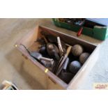 A tray box with miscellaneous contents to include vintage oil cans, croquet balls, flat irons,