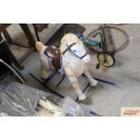 A vintage metalware rocking horse