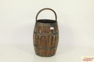 A wooden and brass bound pail with swing handle
