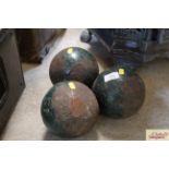 Three large cast iron cannon balls