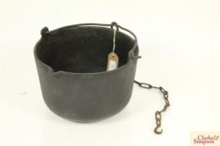 A cast iron cauldron with swing handle