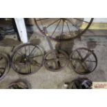 Two iron wheels complete with axles and another