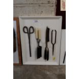 A display board of various vintage curling tongs