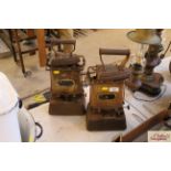 Two vintage oil stoves and two flat irons