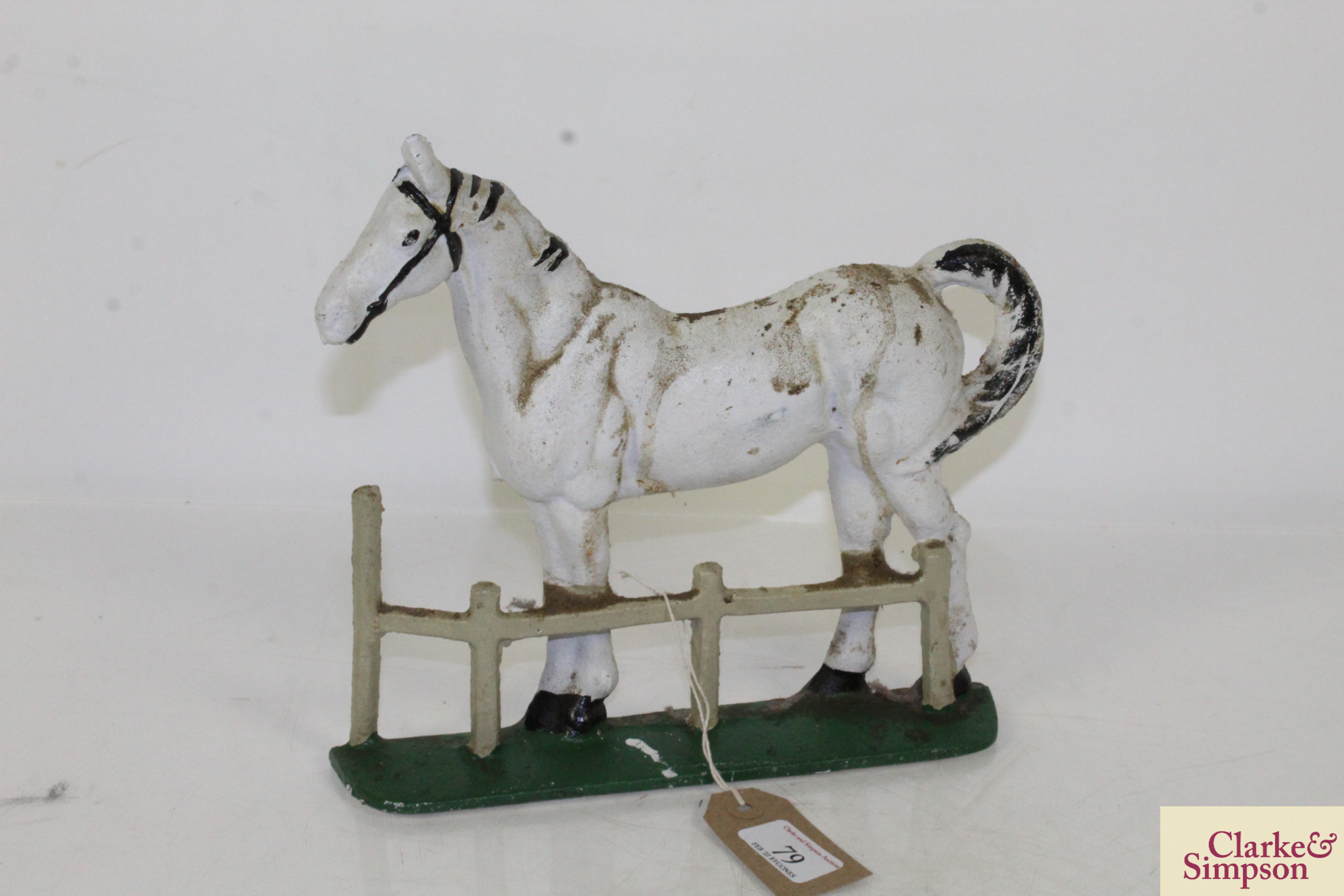 A cast iron horse decorated door stop