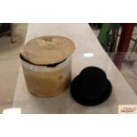 A vintage bowler hat and cardboard hat box (hat b