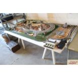 An 8ft x 4ft scratch built N-gauge model railway layout. With three tracks, lit buildings and