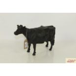 A cast iron model of a cow, measuring approximately 16 inches in length X 9 1/2 inches high to top o