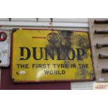 A "Dunlop The First Tyre In The World" enamel adve