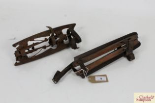 A pair of early wooden strap on ice skates