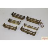Six miniature brass fenders