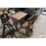 A vintage elm school desk with integral seat