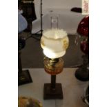 A brass Corinthian column table oil lamp with clea