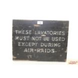 A painted wooden lavatory sign