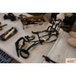 A horse bridle and three tack racks