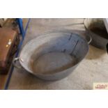 A vintage galvanised twin handled bath