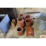 Five various chimney pots, two drainage pipes and