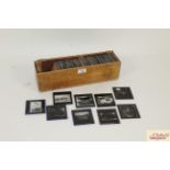 A wooden box and collection of 87 Magic Lantern sl