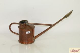 A copper watering can with brass rose