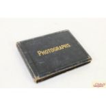 A small antique photograph album containing photog