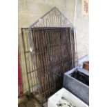 An antique iron work sectional dog kennel