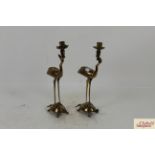 A pair of Oriental bronze candle holders in the fo