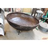 A large iron Kadi / fire pit on scrolled stand, measuring approximately 48 inches in diameter, 18 in