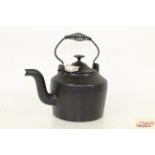 A vintage cast iron kettle with swing handle