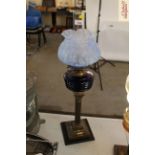 A brass Corinthian column oil lamp with blue glass